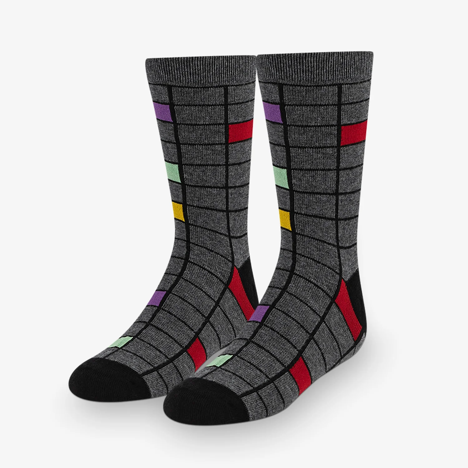 A pair of grey socks with colorful squares on them.